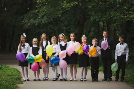 young boys and girls in uniform outdoorsの写真素材