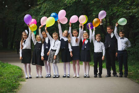 young boys and girls in uniform outdoorsの写真素材