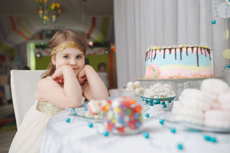 girl with birthday cake at homeの写真素材
