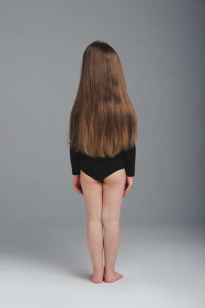 little girl studio portrait on grey backgroundの写真素材