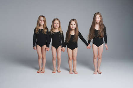 four young beautiful models on greyの写真素材