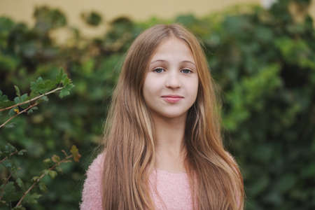 Beautiful young girl posing on the street