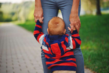 mother holding son by handの写真素材