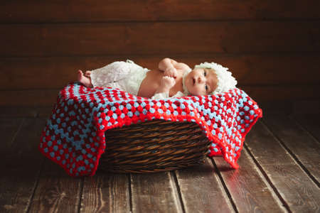 Cute newborn baby in the basketの写真素材