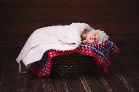 cute newborn baby in the basketの写真素材