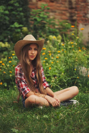 beautiful young cowgirl with long hairの写真素材
