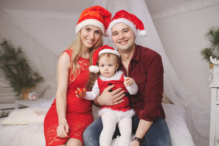 family with santa hats at homeの写真素材