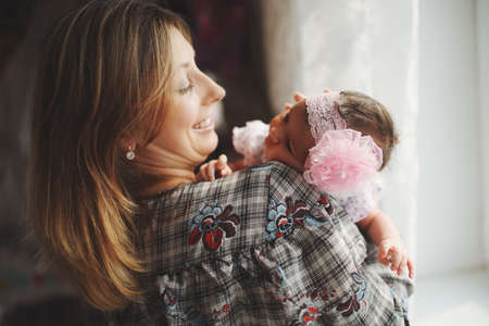 young mother with cute newborn babyの写真素材
