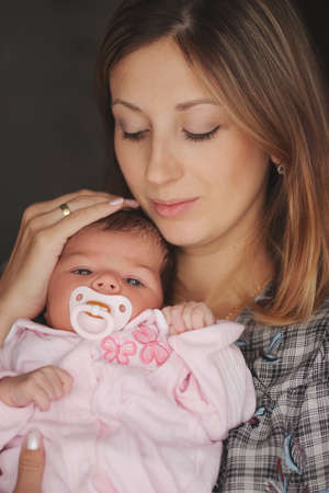 young mother with cute newborn babyの写真素材