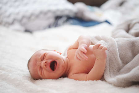 cute newborn baby at homeの写真素材