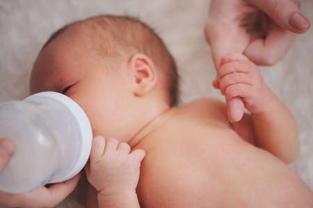 mother holds hand of newborn babyの写真素材