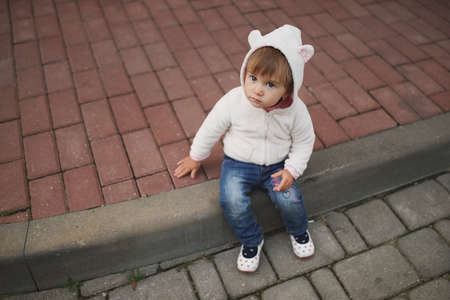 cute little girl in hood with earsの写真素材