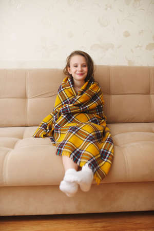 little girl with plaid at homeの写真素材