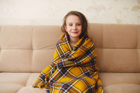 little girl with plaid at homeの写真素材