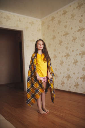 little girl with plaid at homeの写真素材