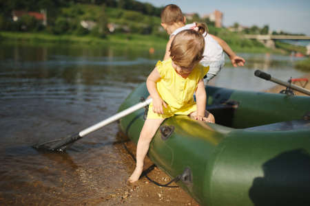 happy boy swimming in fishing boatの写真素材