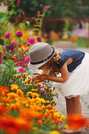 little beautiful girl in flowers parkの写真素材
