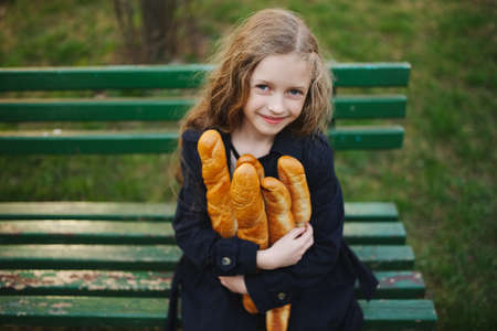 portrait of young beautiful girl with baguette