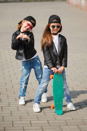 stylish funny little girls on the streetの写真素材