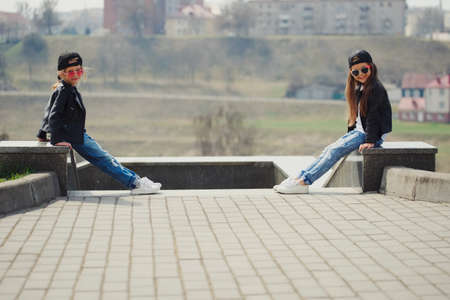 stylish funny little girls on the streetの写真素材