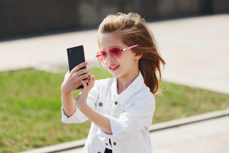 stylish funny little girl on the street