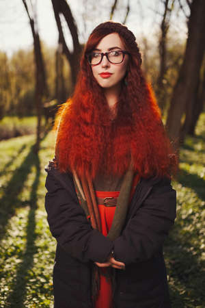 red haired girl in the forestの写真素材