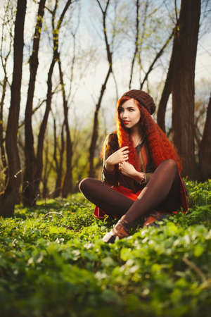 red haired girl in the forestの写真素材