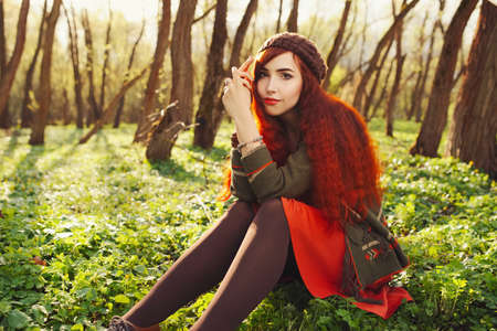 red haired girl in the forestの写真素材