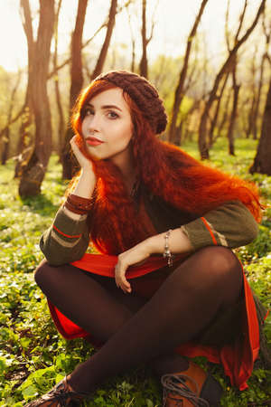 red haired girl in the forestの写真素材