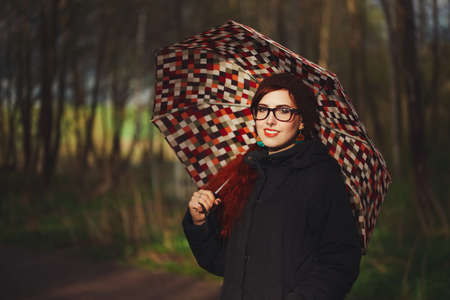 red haired girl in the forestの写真素材