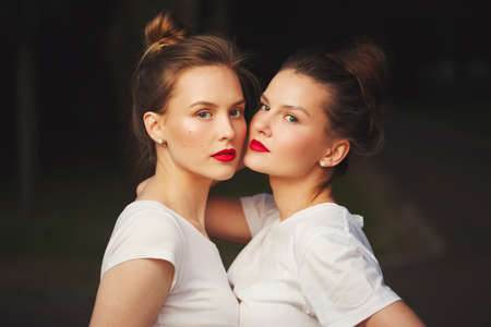 two beautiful girls with red lipsの写真素材