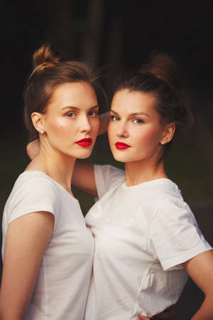 two beautiful girls with red lipsの写真素材