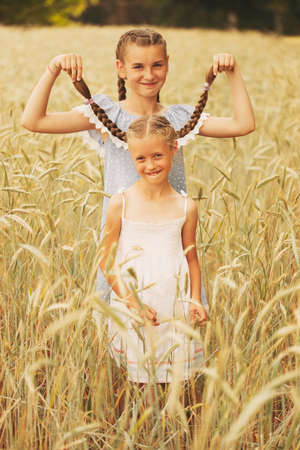 young girl in the yellow fieldの写真素材
