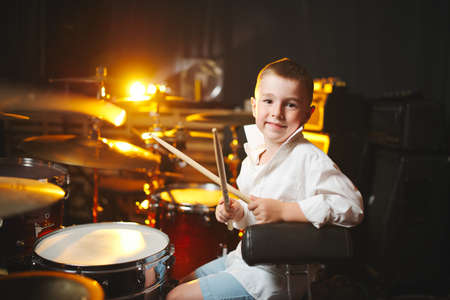 boy plays drums in recording studioの写真素材