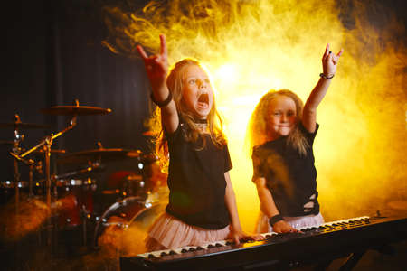 little girl play on synthesizer in music studioの写真素材