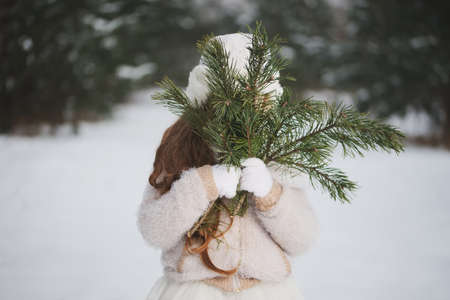 little happy beautiful girl in winter forest