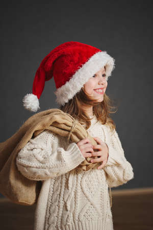 little beautiful girl with red santa hatの写真素材
