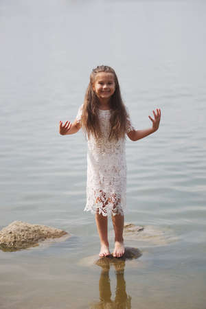 cute happy little girl in sumer lake