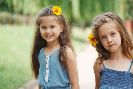 photo of two little girls in summer parkの写真素材