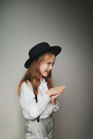cute little girl with black hat at homeの写真素材