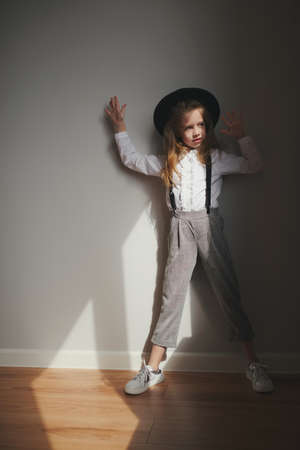 cute little girl with black hat at homeの写真素材
