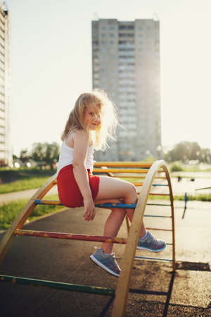 little girl has fun on monkey barの写真素材