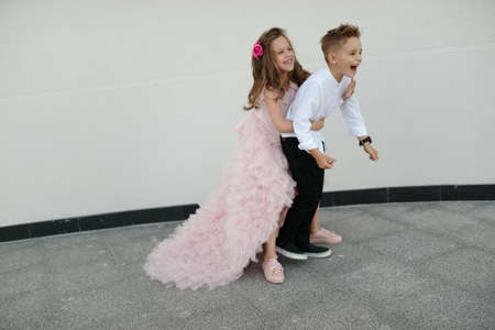 young happy boy and girl together outdoorsの写真素材