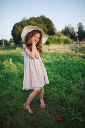 little girl in linen dress in countrysideの写真素材