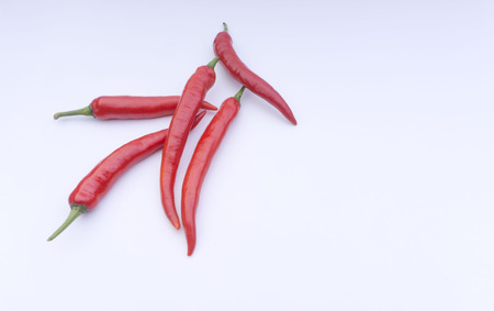 Closeup of red chillies isolated on white background.の写真素材