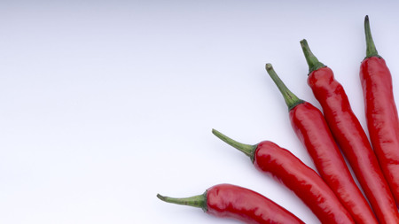 Closeup of red chillies isolated on white background.