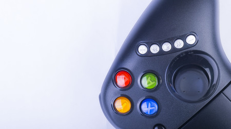 Closeup of black game controller isolated on white backgroundの写真素材