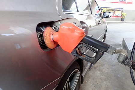 Handle fuel nozzel to refuel. Selective focus and crop fragment.のeditorial素材