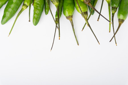 Green Bird's eye chili ,Thai Chili pepper ,bird chili pepper nature isolate on white background. Selective focus and crop fragmentの写真素材