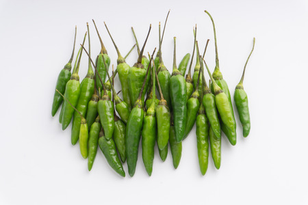Green Bird's eye chili ,Thai Chili pepper ,bird chili pepper nature isolate on white background. Selective focus and crop fragmentの写真素材